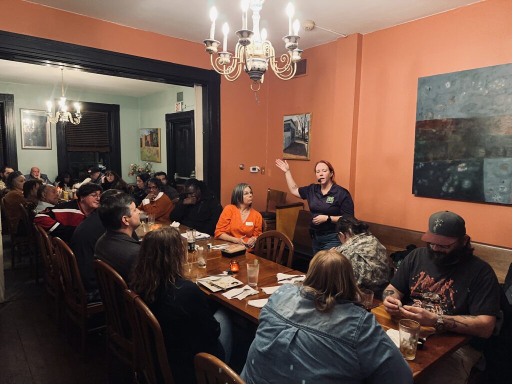 Guide sharing a ghost story in the parlor at Patrick Henry Pub.