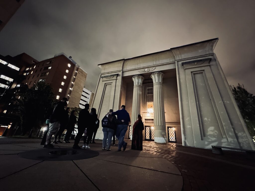 Tour group listening to a guide during a Specters and Shades of Court End tour at the Egyptian Building in Richmond, Virginia.