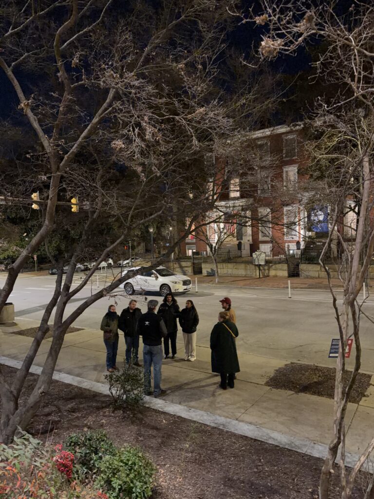 Tour group listening to a guide during a Phantoms of Franklin tour by the Linden Row Inn in Richmond, Virginia.
