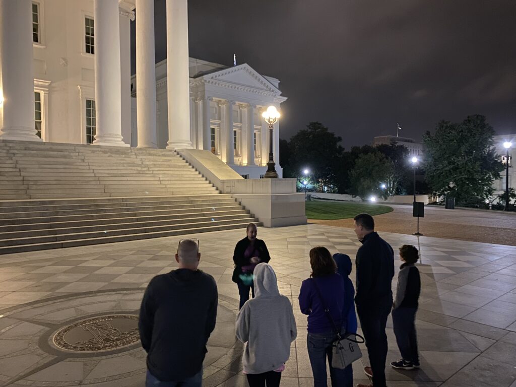 Tour group listening to a guide during a Haunted Capitol Hill tour at the Virginia State Capitol in Richmond.