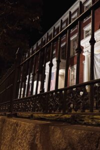 Linden Row Inn at night viewed through its historic wrought-iron fence in Richmond, Virginia.