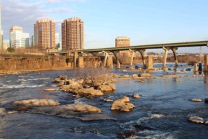 James River flowing past downtown Richmond, Virginia, with bridges and the city skyline in the background.